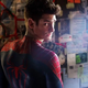 A maskless Spider-Man looks back over his shoulder while standing before a conspiracy theory wall.